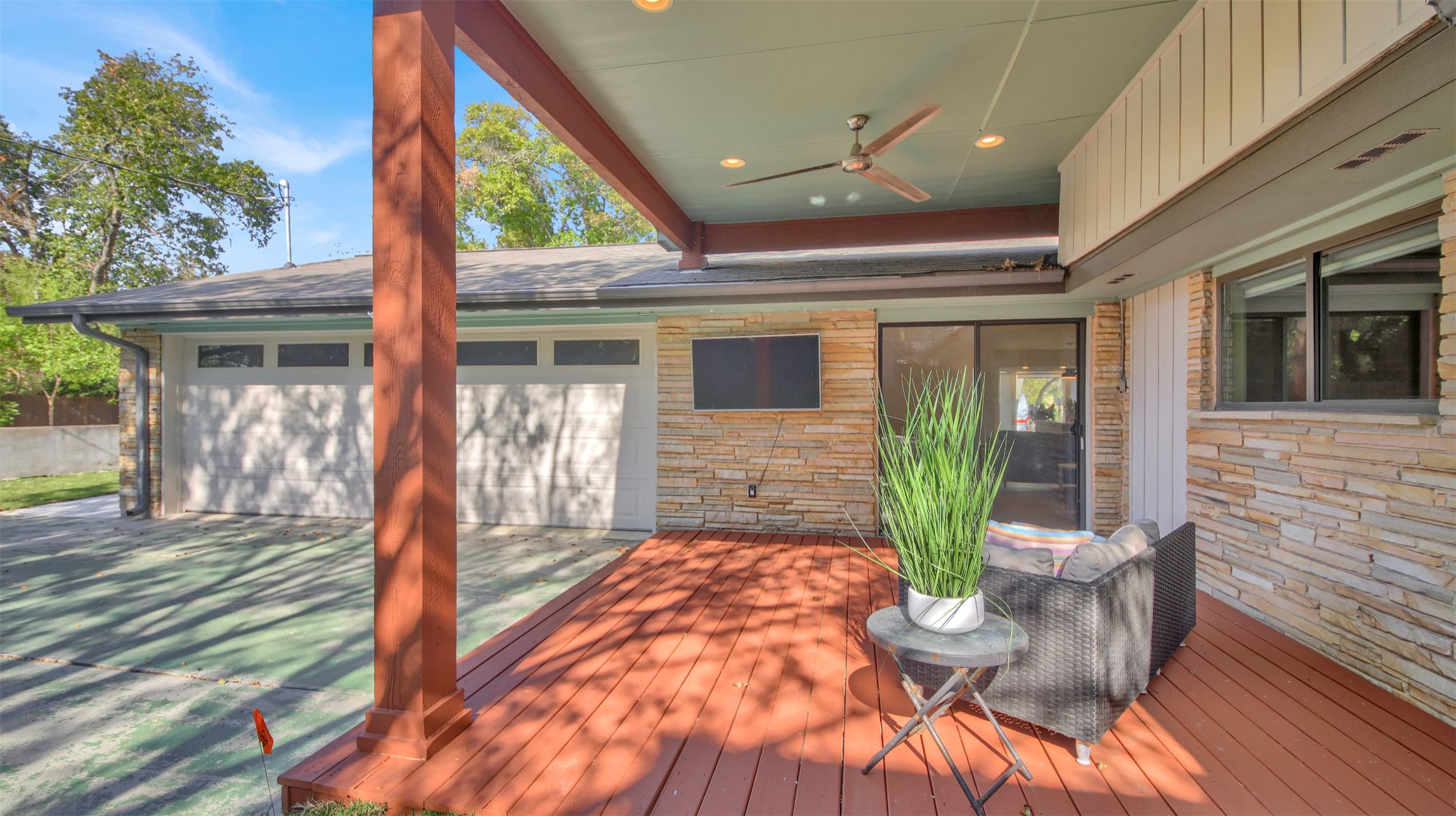 7510 Daugherty Street Austin, TX 78757 - Photo 19 of 37 Wooden deck featuring an attached garage and ceiling fan