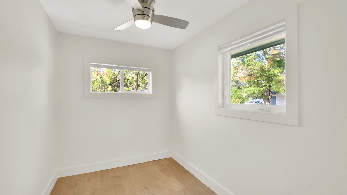 7510 Daugherty Street Austin, TX 78757 - Photo 21 of 37 Spare room with light wood-style floors and ceiling fan