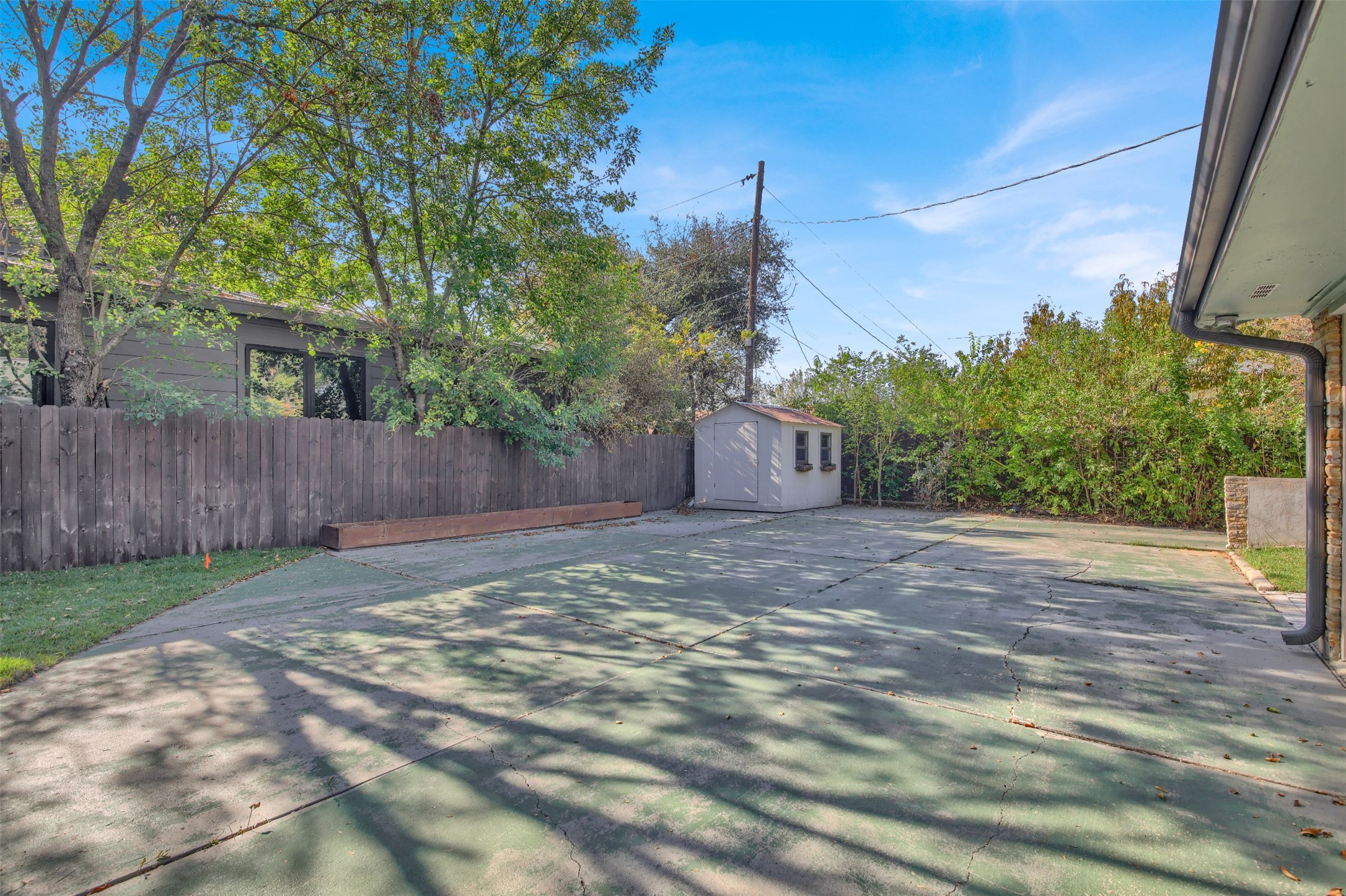 7510 Daugherty Street Austin, TX 78757 - Photo 21 of 37 Fenced yard featuring a storage shed