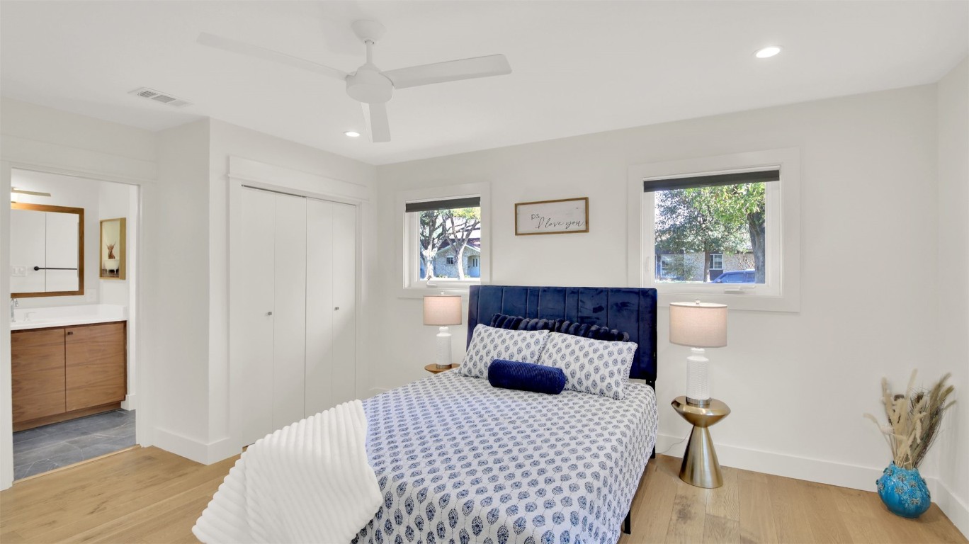 7510 Daugherty Street Austin, TX 78757 - Photo 26 of 37 Bedroom with a closet, light wood-type flooring, recessed lighting, ceiling fan, and ensuite bath