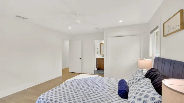 a bedroom with a bed and wooden floor