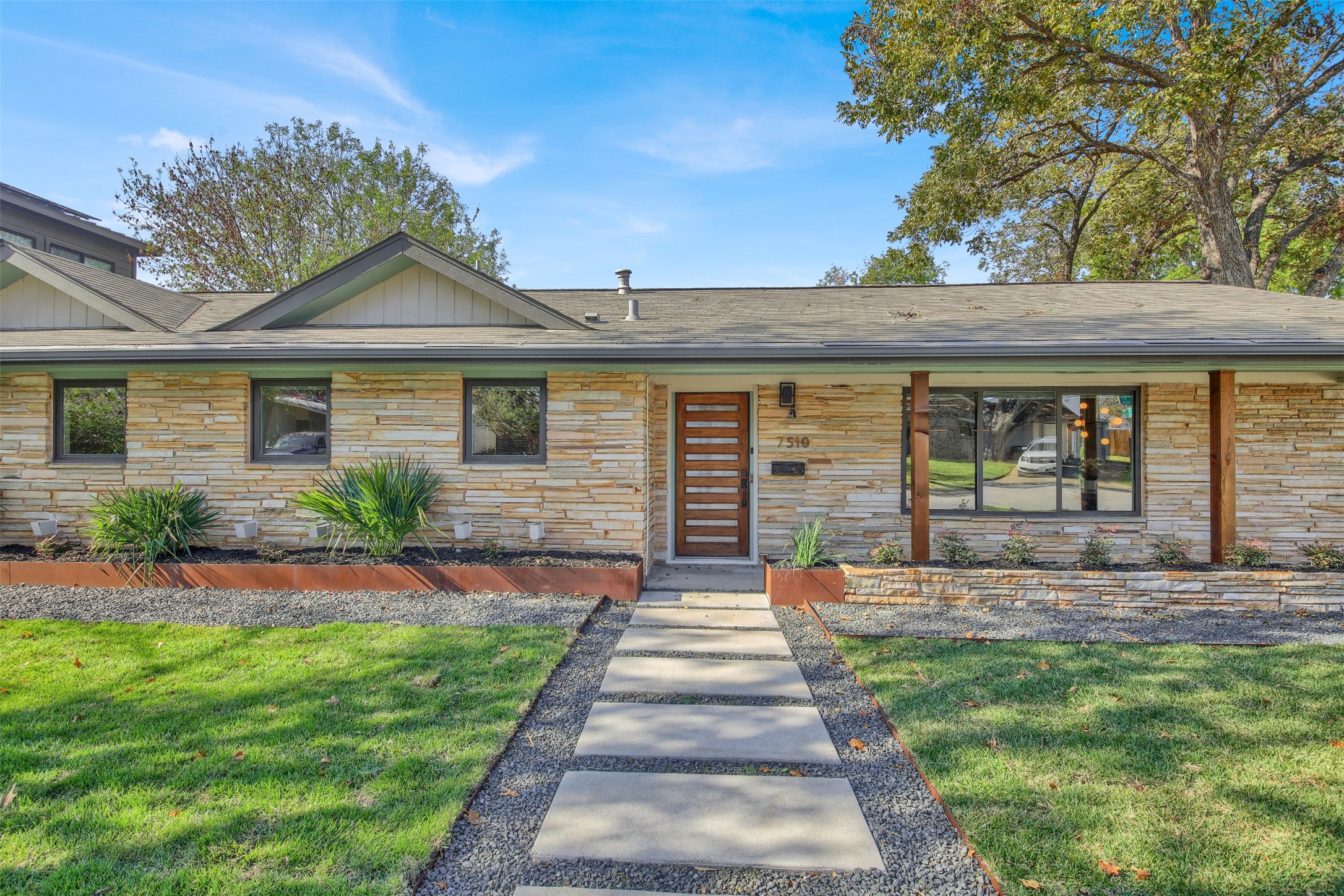 7510 Daugherty Street Austin, TX 78757 - Photo 6 of 37 View of front of home featuring stone siding and a front lawn