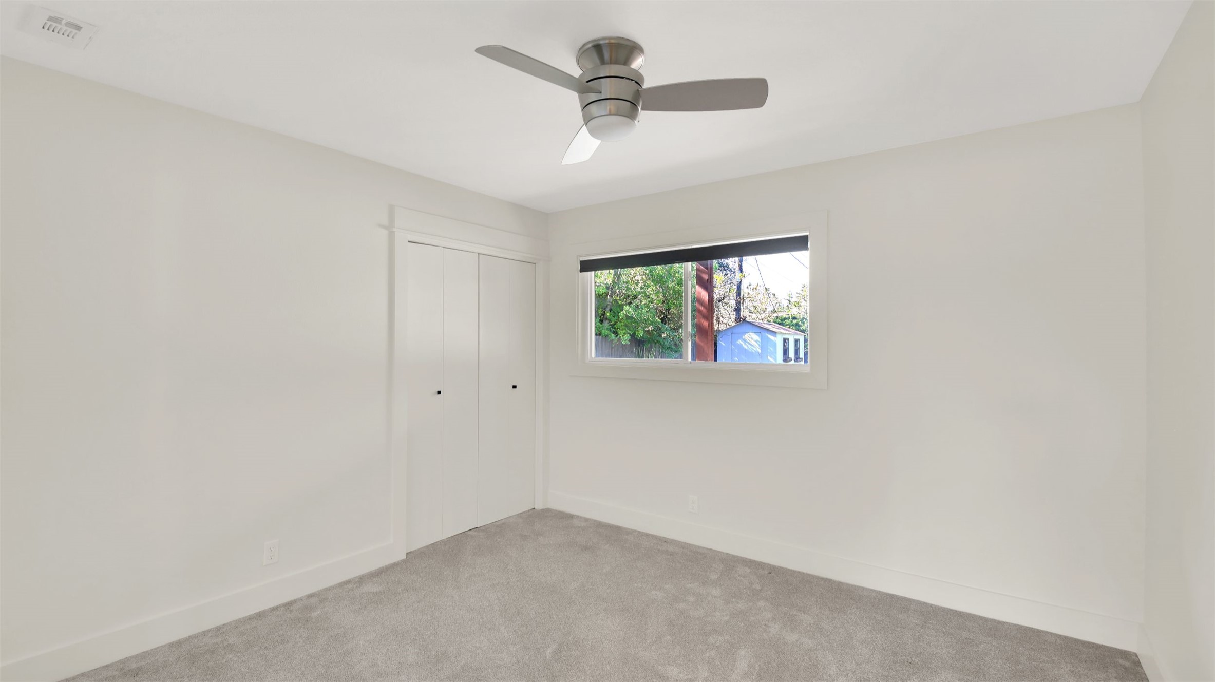 7510 Daugherty Street Austin, TX 78757 - Photo 7 of 37 Unfurnished bedroom featuring carpet, a closet, and ceiling fan
