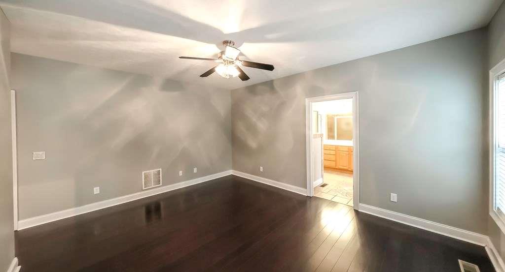111 Watson Drive Bremen, GA 30110 - Photo 20 of 60 an empty room with wooden floor fan and windows