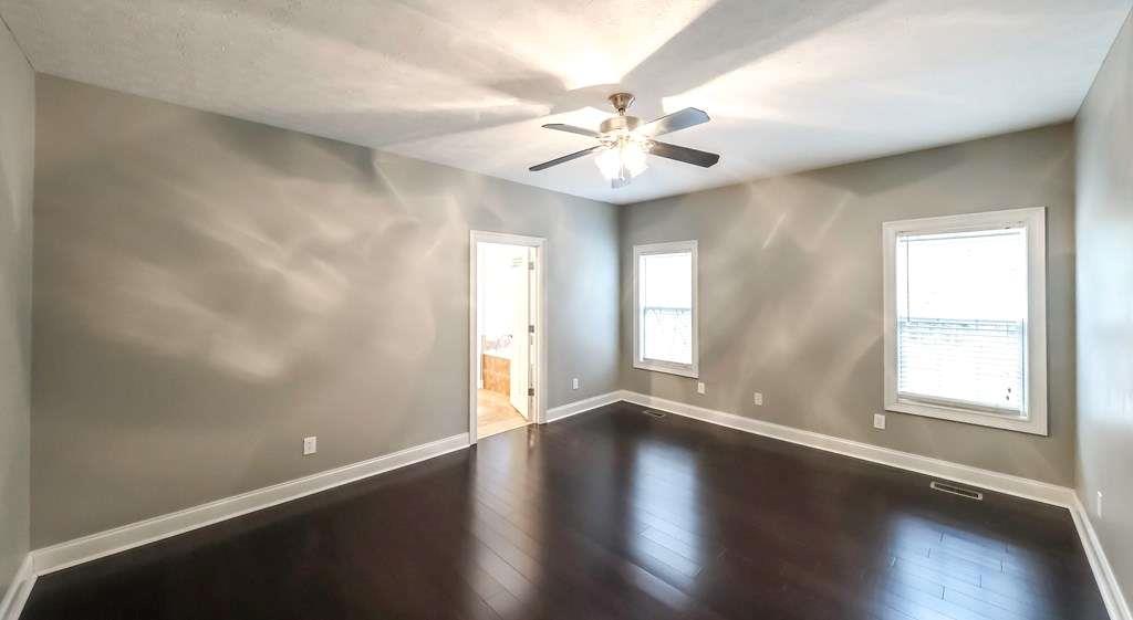 111 Watson Drive Bremen, GA 30110 - Photo 21 of 60 an empty room with wooden floor and windows
