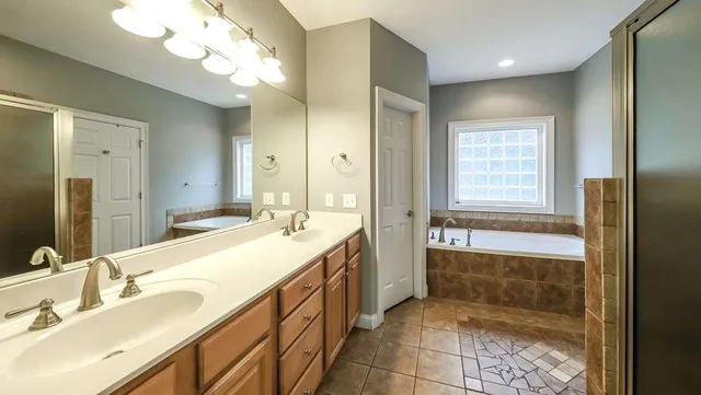 a bathroom with a bathtub and next to a window