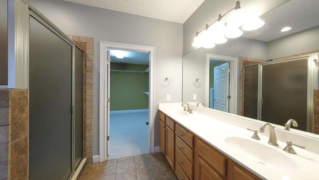 111 Watson Drive Bremen, GA 30110 - Photo 23 of 60 a bathroom with a double vanity sink and a mirror