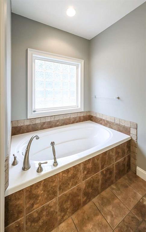 111 Watson Drive Bremen, GA 30110 - Photo 24 of 60 a bathroom with a bathtub and next to a window