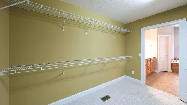 a bathroom with a granite countertop sink a toilet and a mirror