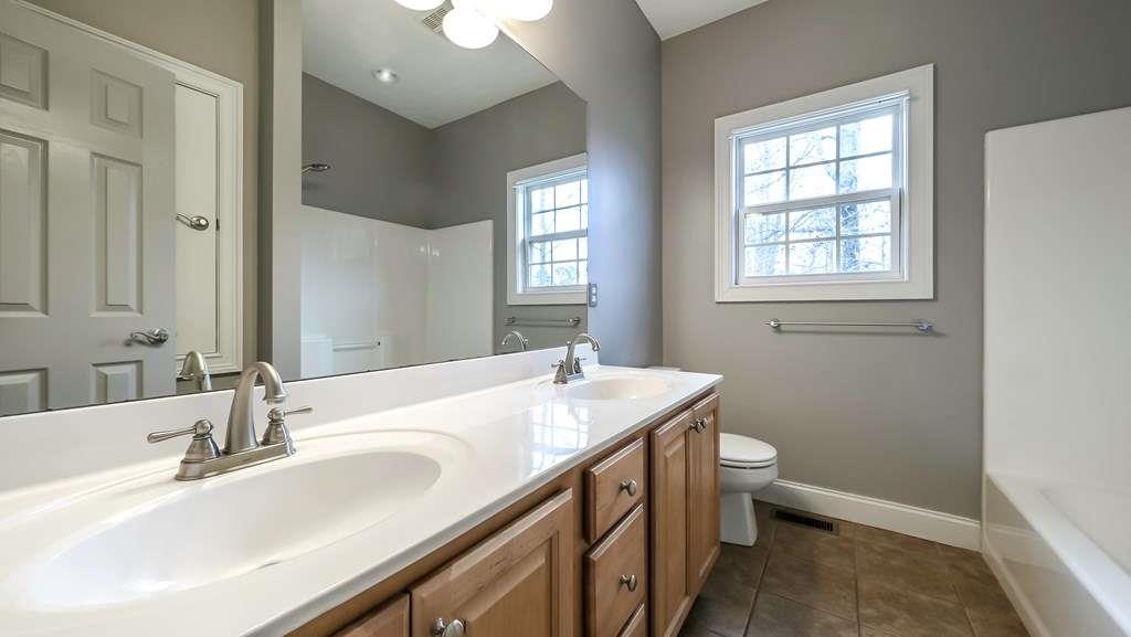 111 Watson Drive Bremen, GA 30110 - Photo 30 of 60 a bathroom with a granite countertop sink a toilet and a mirror