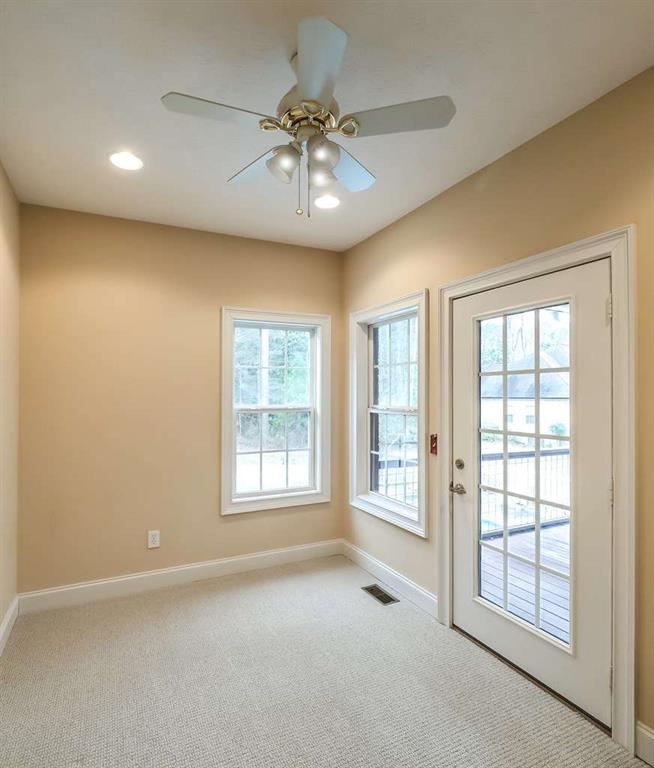 111 Watson Drive Bremen, GA 30110 - Photo 40 of 60 an empty room with chandelier fan and windows