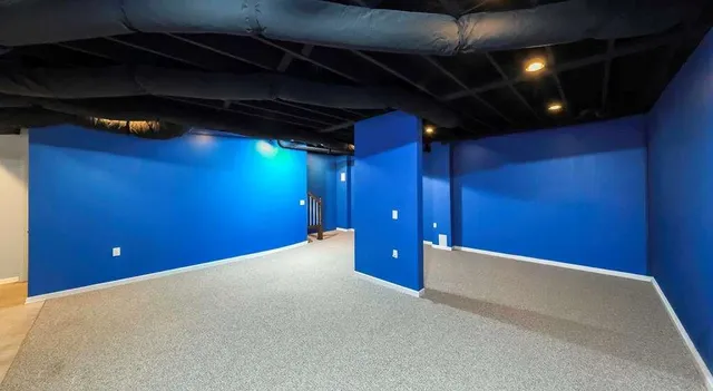 a front view of house with yard and trees in the background