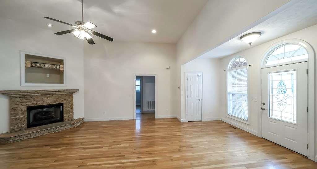 111 Watson Drive Bremen, GA 30110 - Photo 8 of 60 a view of a livingroom with a fireplace a ceiling fan and windows