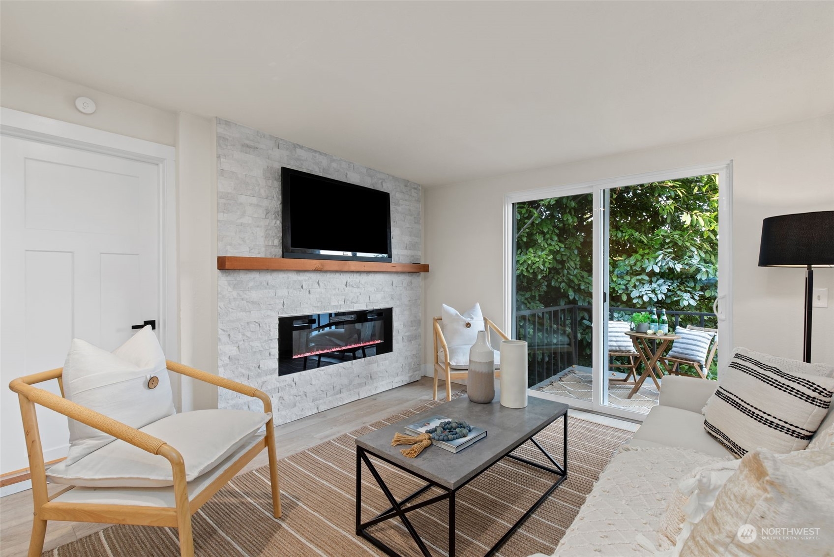 208 South 101st Street Seattle, WA 98168 - Photo 13 of 37 a living room with furniture a fireplace and a flat screen tv