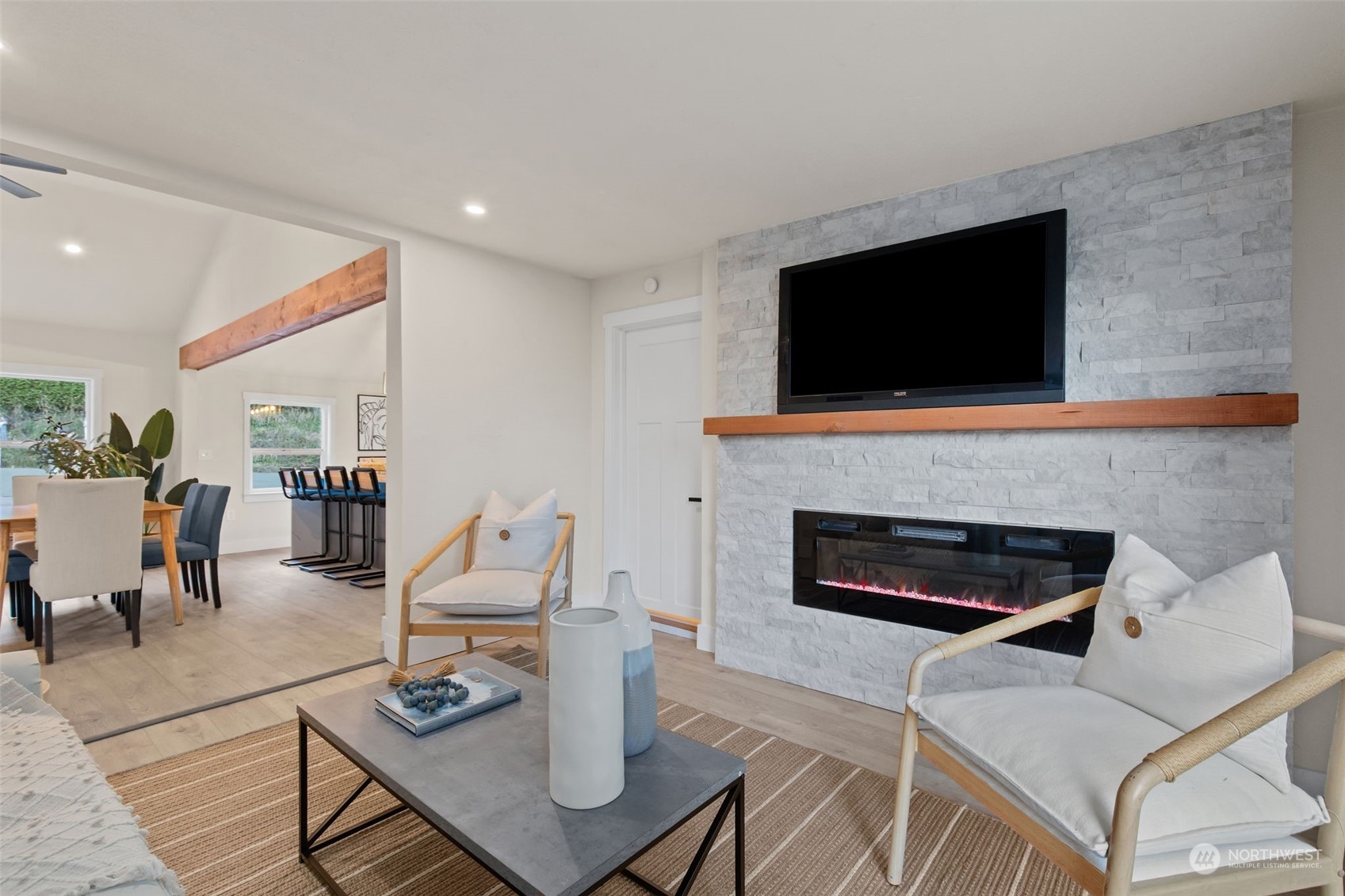 208 South 101st Street Seattle, WA 98168 - Photo 16 of 37 a living room with furniture a fireplace and a flat screen tv