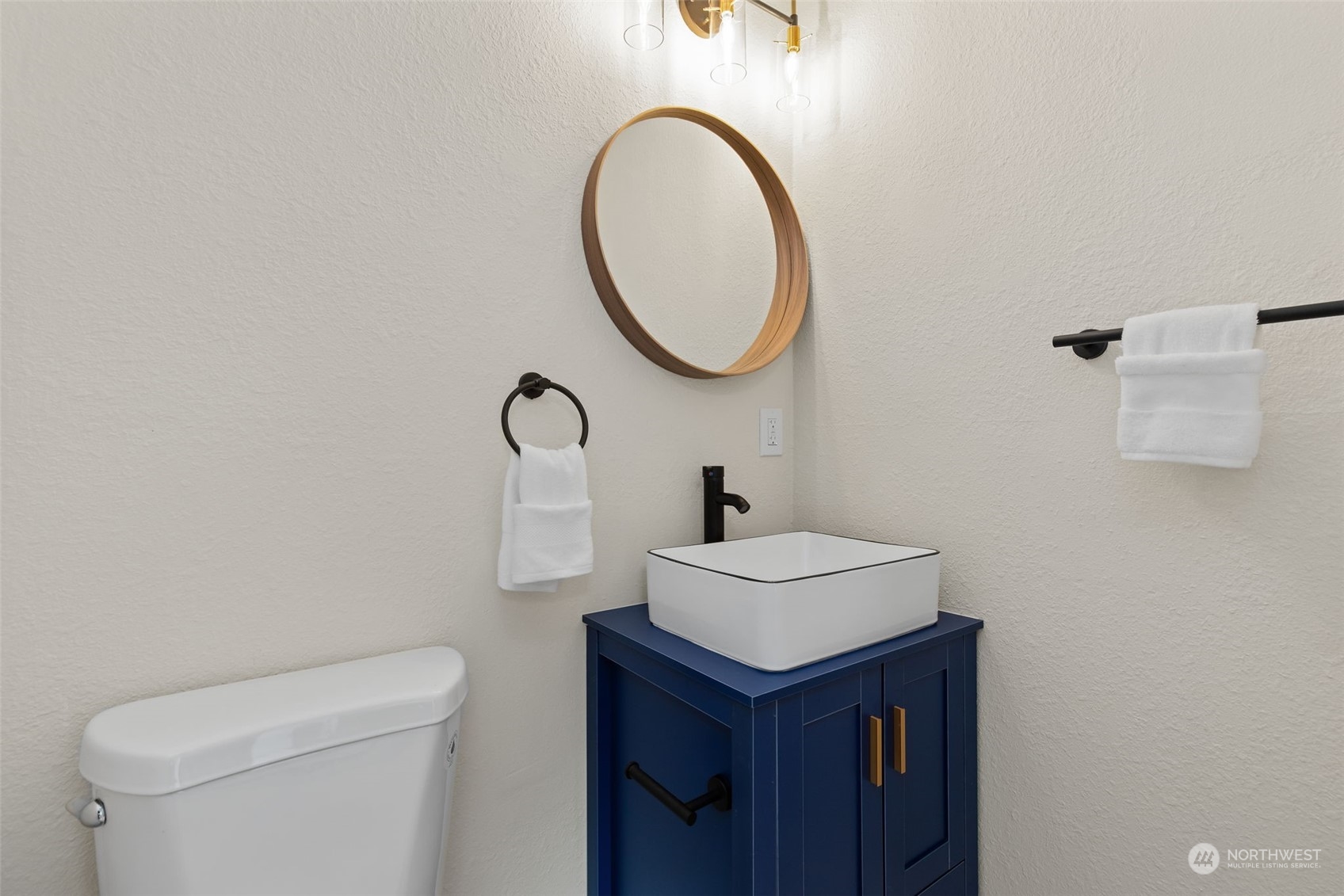 208 South 101st Street Seattle, WA 98168 - Photo 21 of 37 a bathroom with a sink a toilet and a mirror