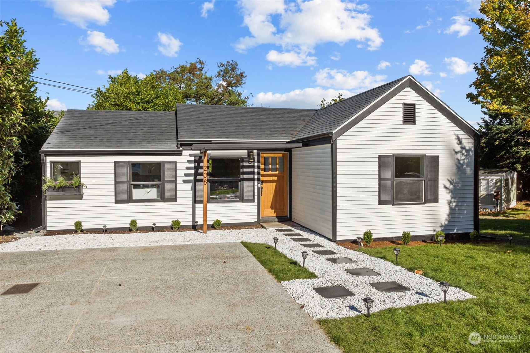 208 South 101st Street Seattle, WA 98168 - Photo 36 of 37 a front view of a house with garden