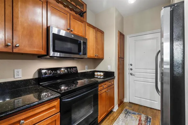 a kitchen with stainless steel appliances granite countertop a stove and a microwave