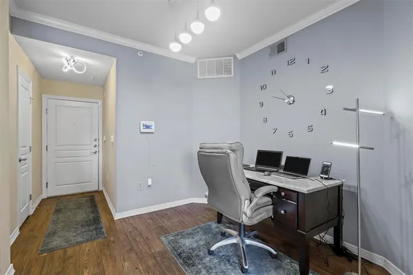 a view of a workspace with furniture and wooden floor