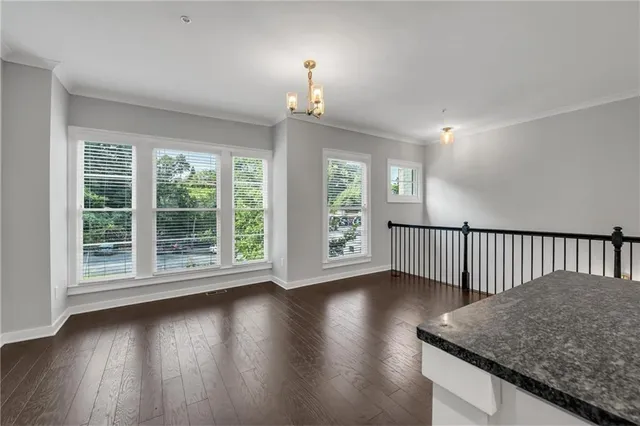 a kitchen with a wooden floor and window