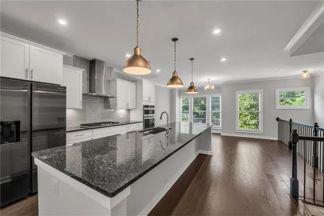 a kitchen with kitchen island a sink a stove and a window