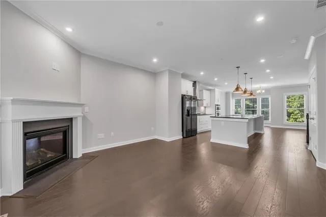 a view of a hallway with wooden floor and entryway