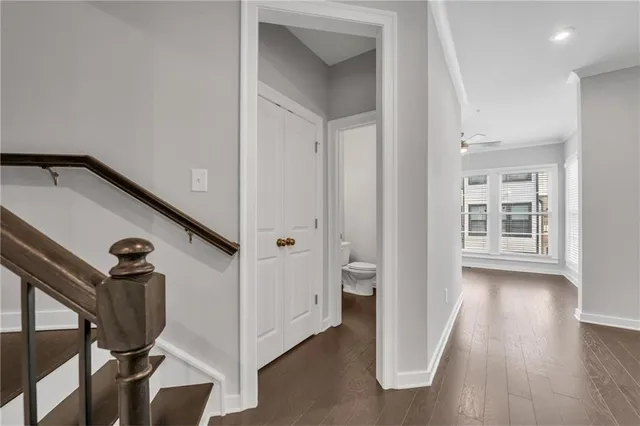 a view of a big yard with flower plants and wooden fence