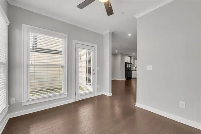 a view of a hallway with wooden floor and stairs