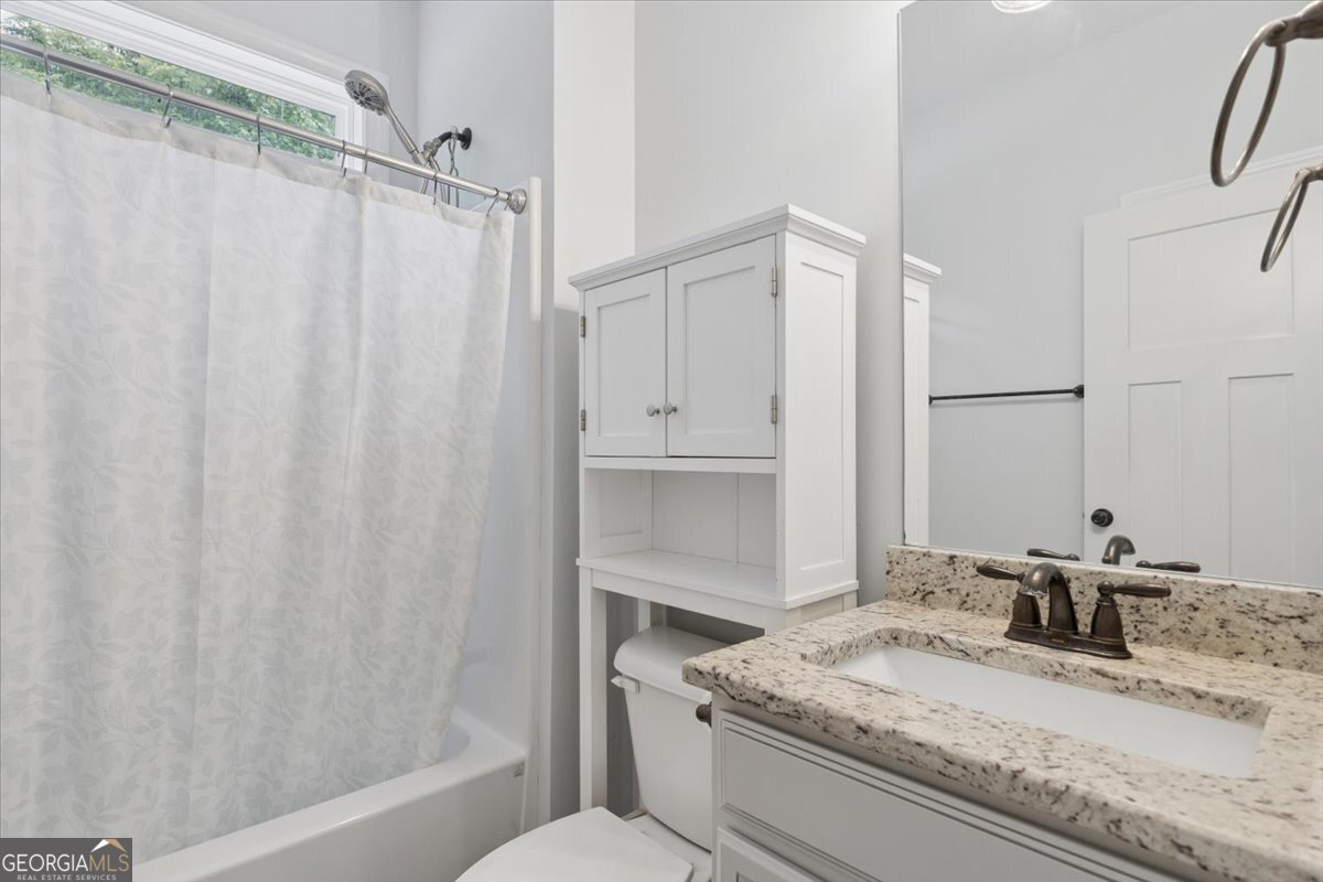 683 Teagle Road Forsyth, GA 31029 - Photo 20 of 50 a bathroom with a granite countertop sink and a mirror