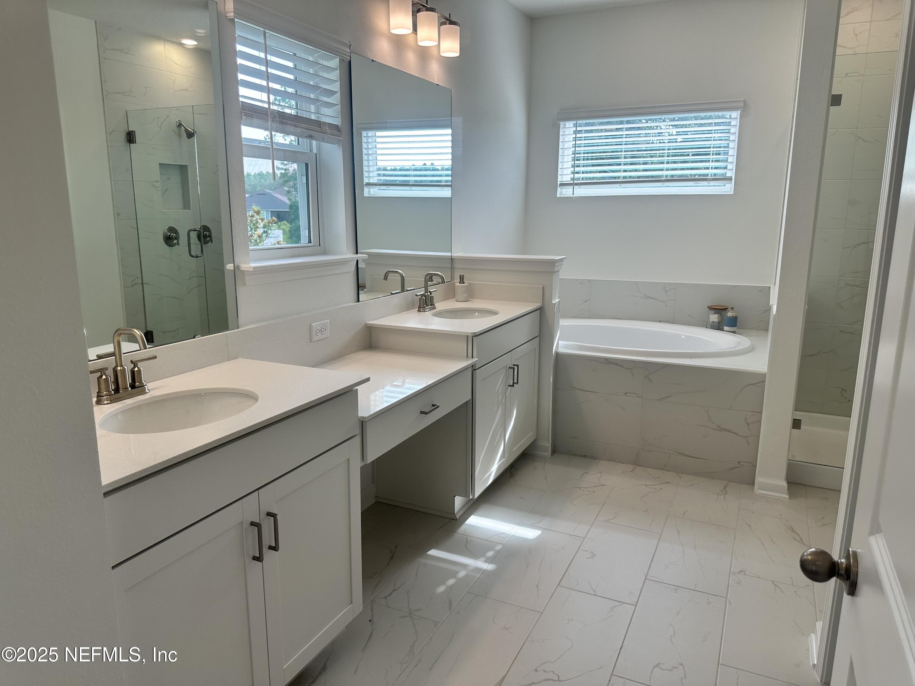 34 Twilight Lane St. Augustine, FL 32095 - Photo 17 of 20 a bathroom with a tub sink shower and mirror