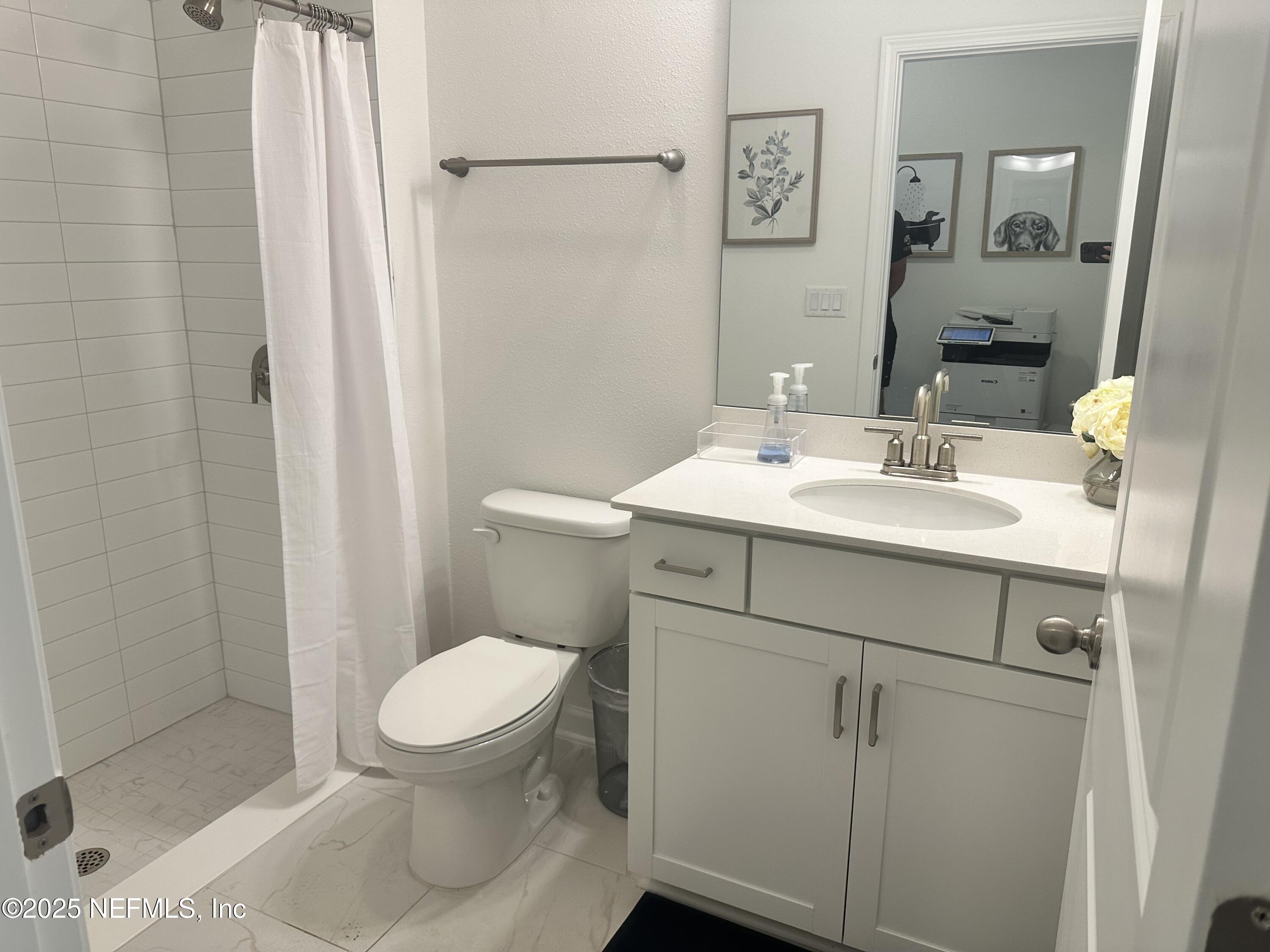 34 Twilight Lane St. Augustine, FL 32095 - Photo 18 of 20 a bathroom with a sink a toilet a mirror and shower