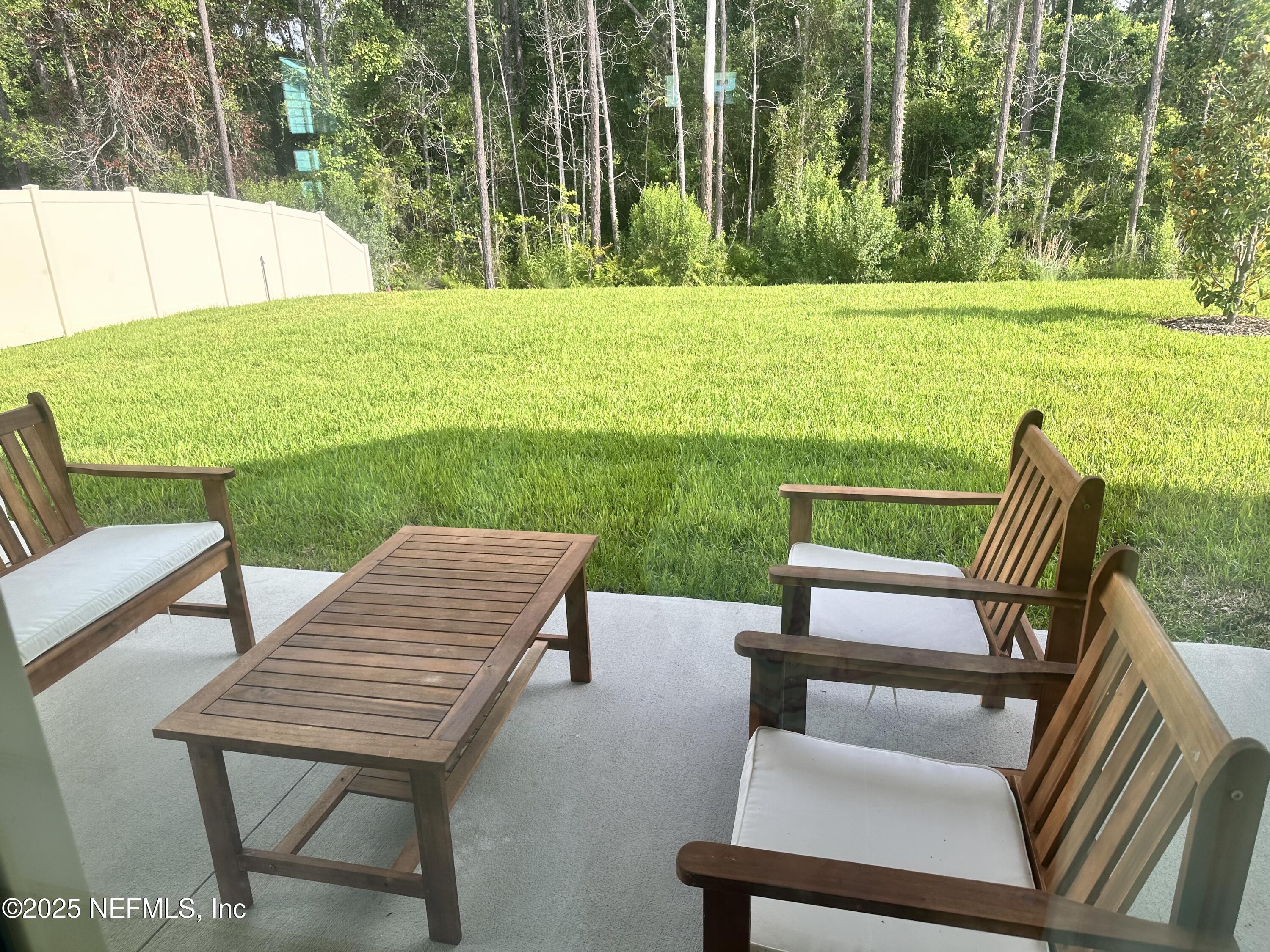 34 Twilight Lane St. Augustine, FL 32095 - Photo 20 of 20 a view of a chairs and table in patio next to a yard