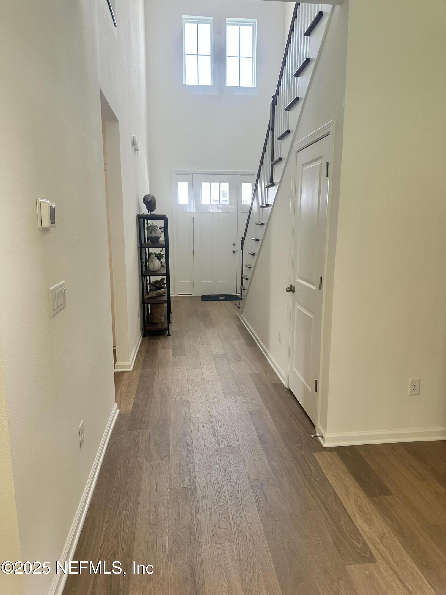 34 Twilight Lane St. Augustine, FL 32095 - Photo 2 of 20 a view of a hallway with wooden floor and stairs