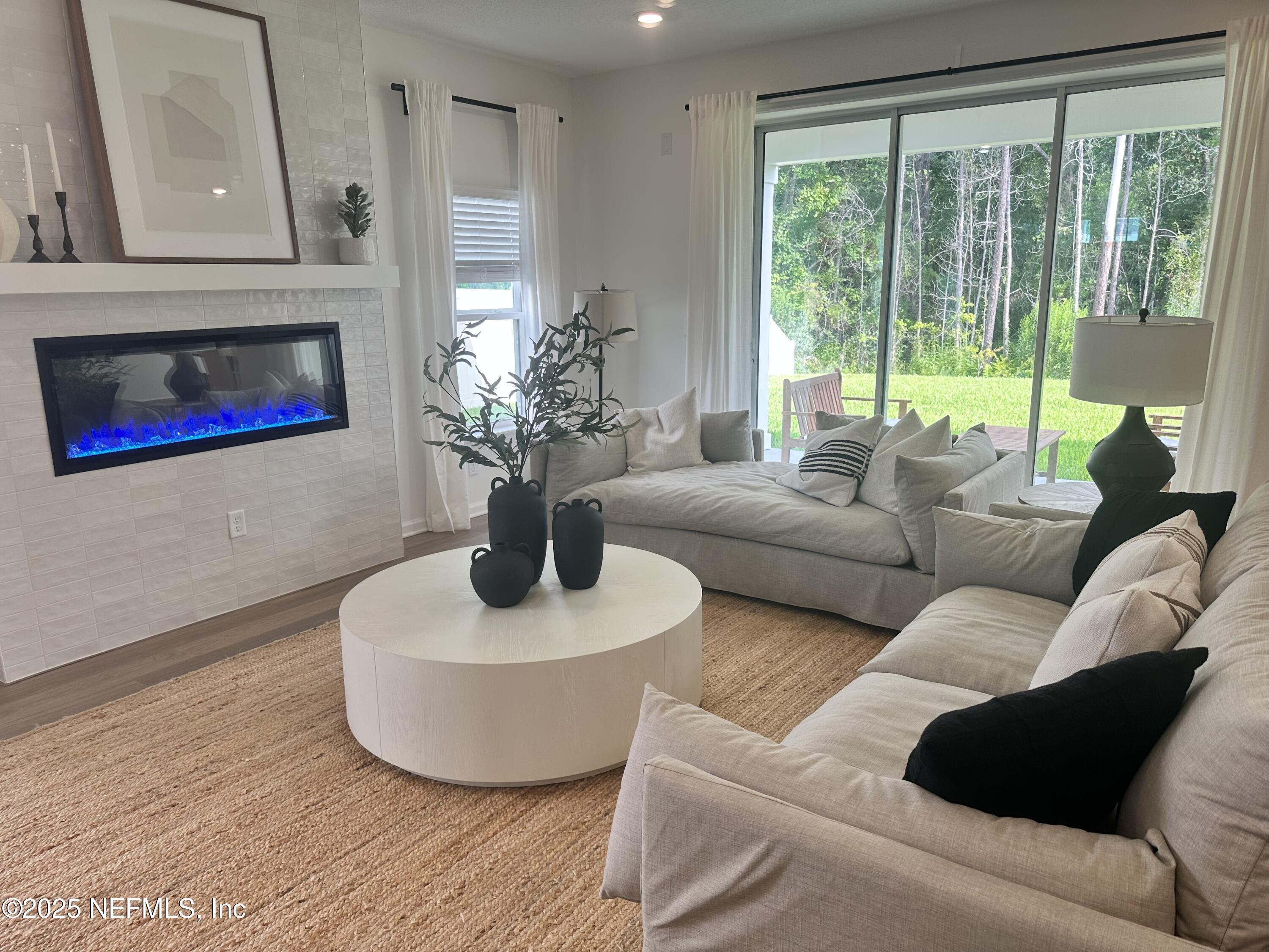 34 Twilight Lane St. Augustine, FL 32095 - Photo 3 of 20 a living room with furniture potted plant and a fireplace