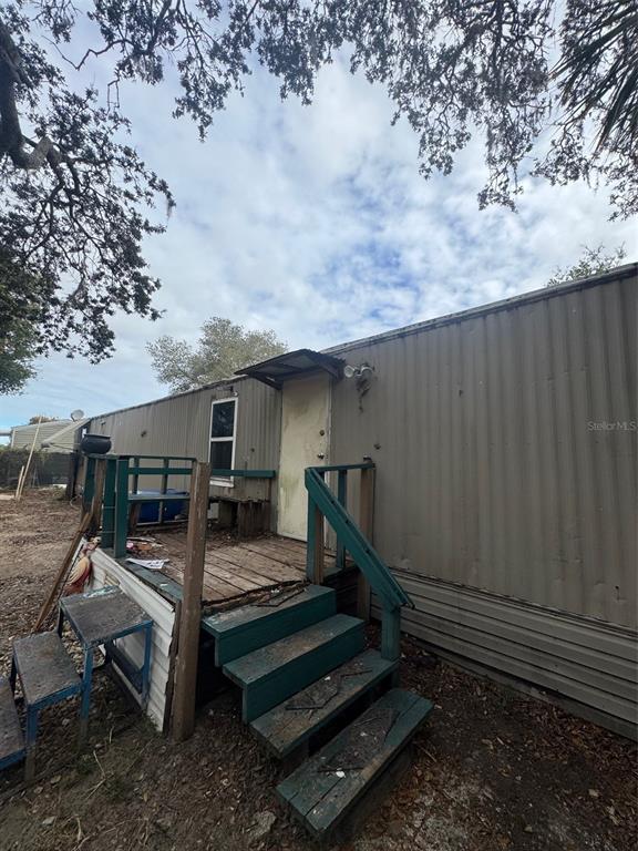 6631 Celeste Lane New Port Richey, FL 34653 - Photo 5 of 13 a backyard of a house with barbeque oven table and chairs
