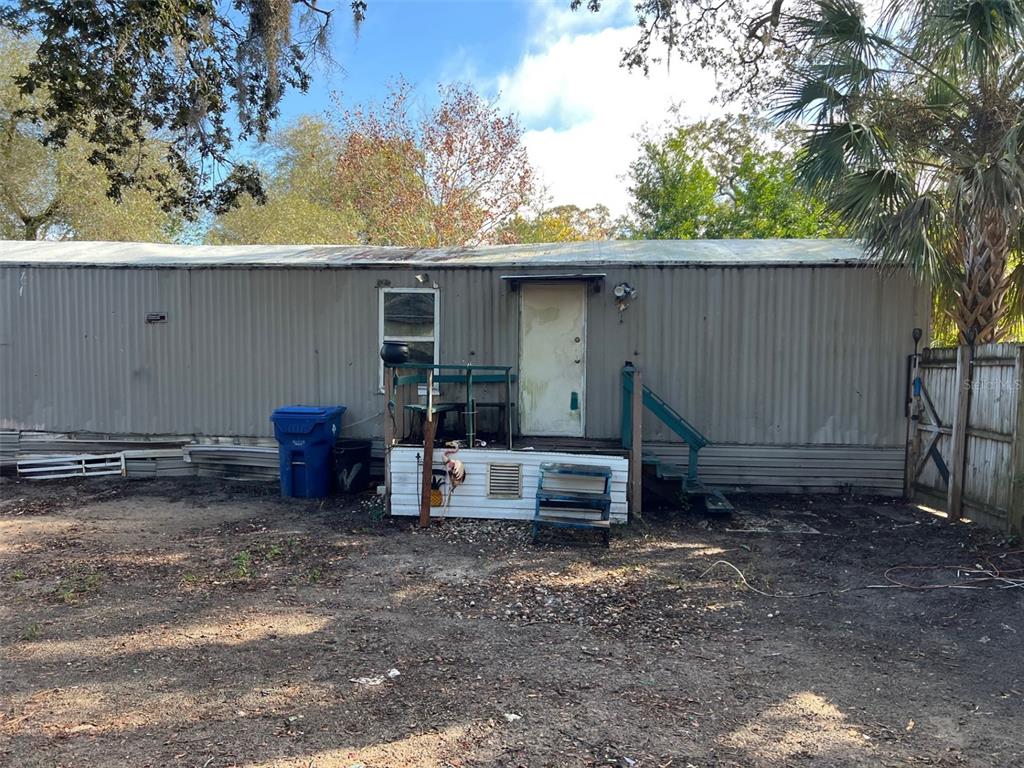6631 Celeste Lane New Port Richey, FL 34653 - Photo 6 of 13 a backyard of a house with barbeque oven and outdoor seating