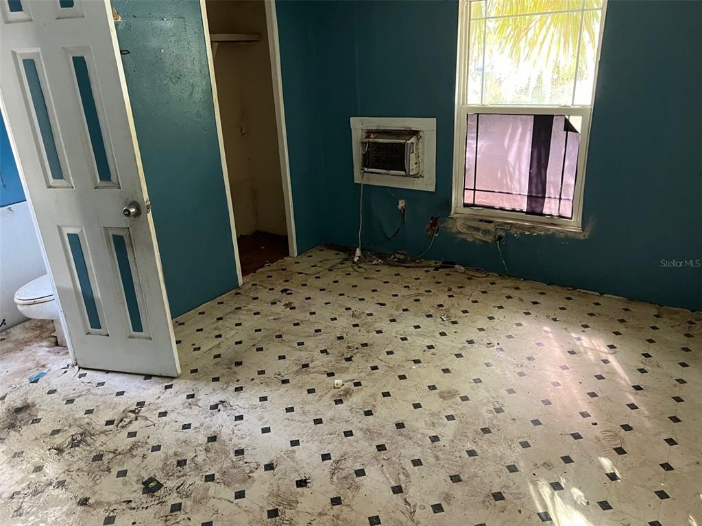 6631 Celeste Lane New Port Richey, FL 34653 - Photo 10 of 13 a bedroom with a bed and a window