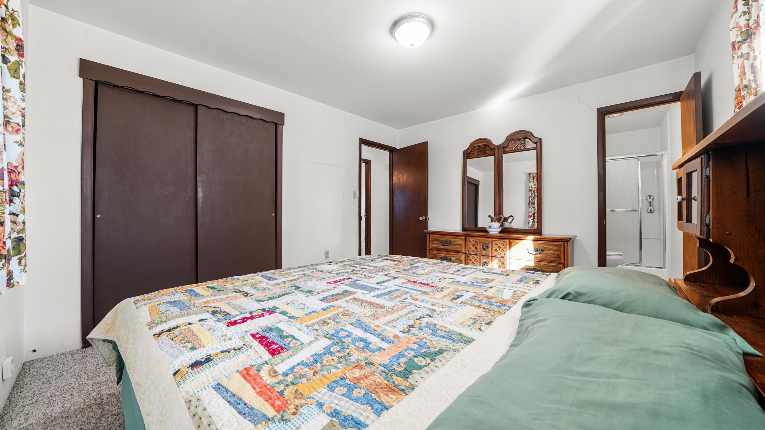 582 36 Road Palisade, CO 81526 - Photo 13 of 31 a bedroom with a bed a mirror and dresser