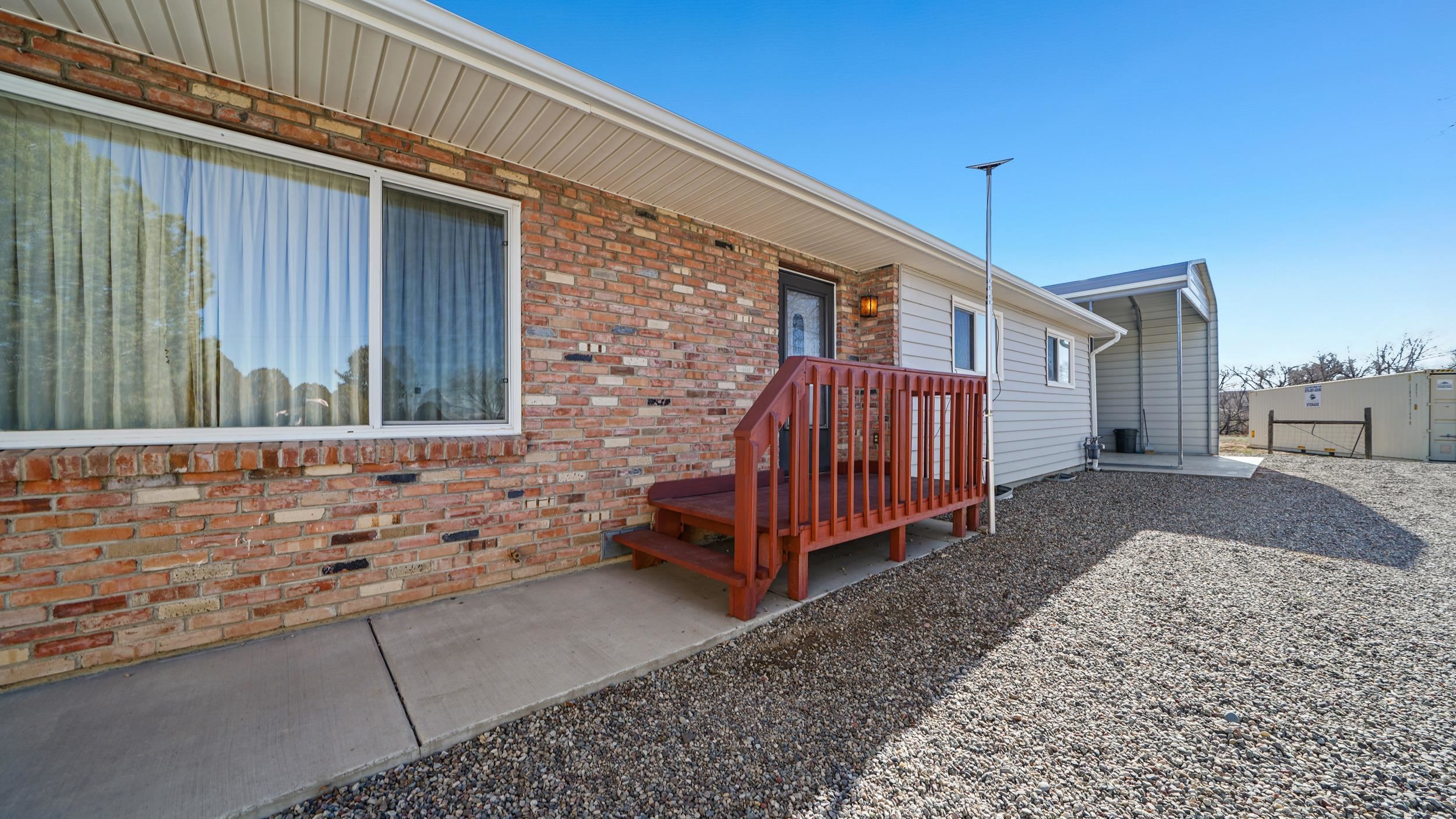 582 36 Road Palisade, CO 81526 - Photo 2 of 31 a small white house with a outdoor space