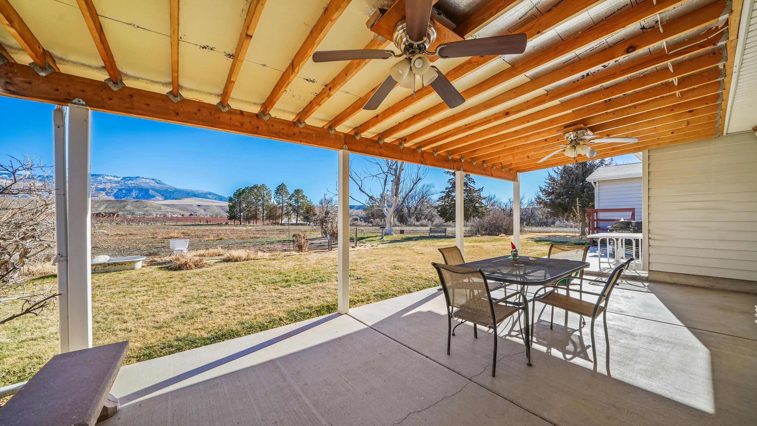 582 36 Road Palisade, CO 81526 - Photo 25 of 31 a view of a patio with a table chairs and wooden floor