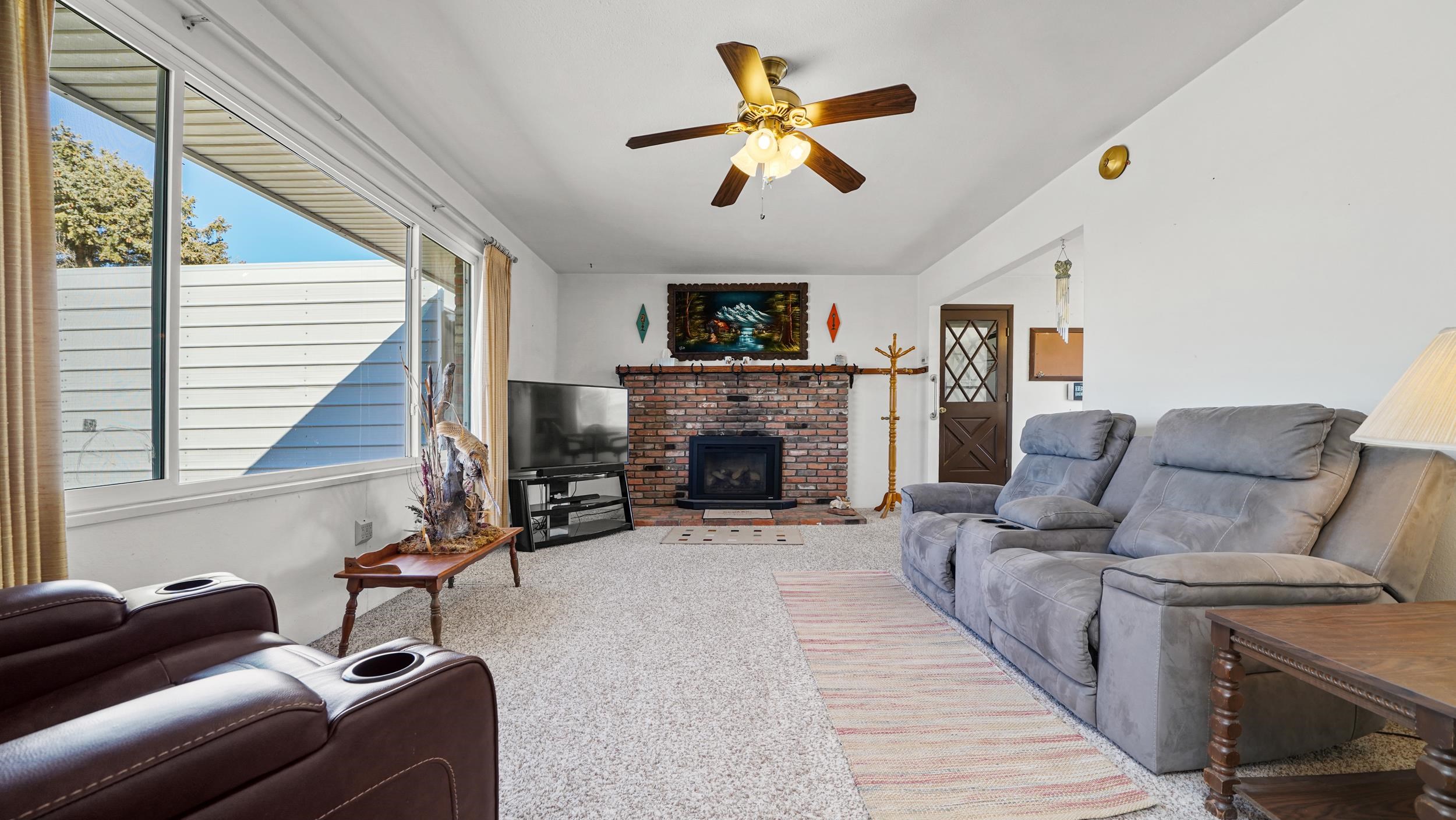 582 36 Road Palisade, CO 81526 - Photo 5 of 31 a living room with furniture a fireplace and a window