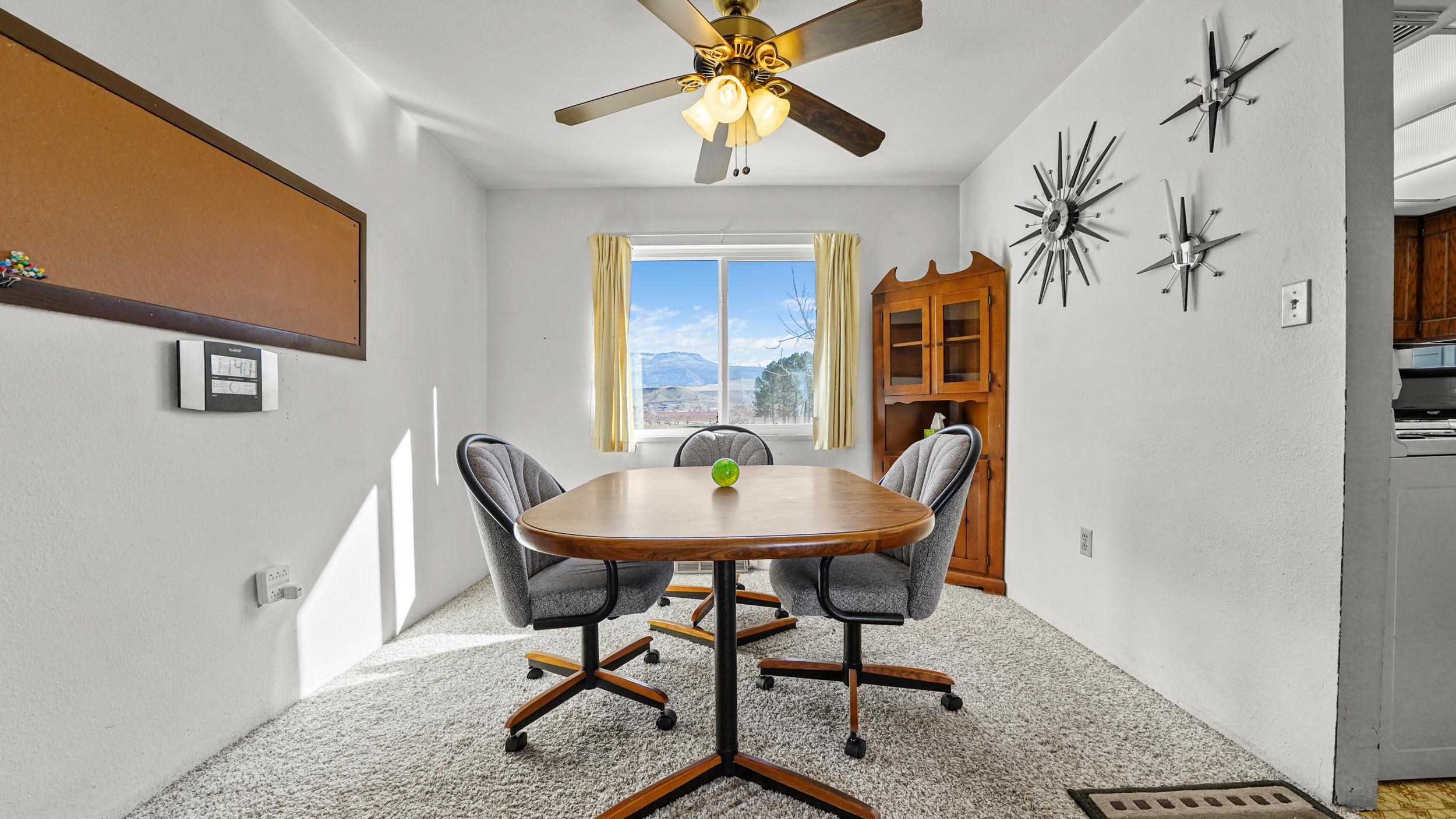 582 36 Road Palisade, CO 81526 - Photo 7 of 31 a view of a dining room with furniture and a chandelier