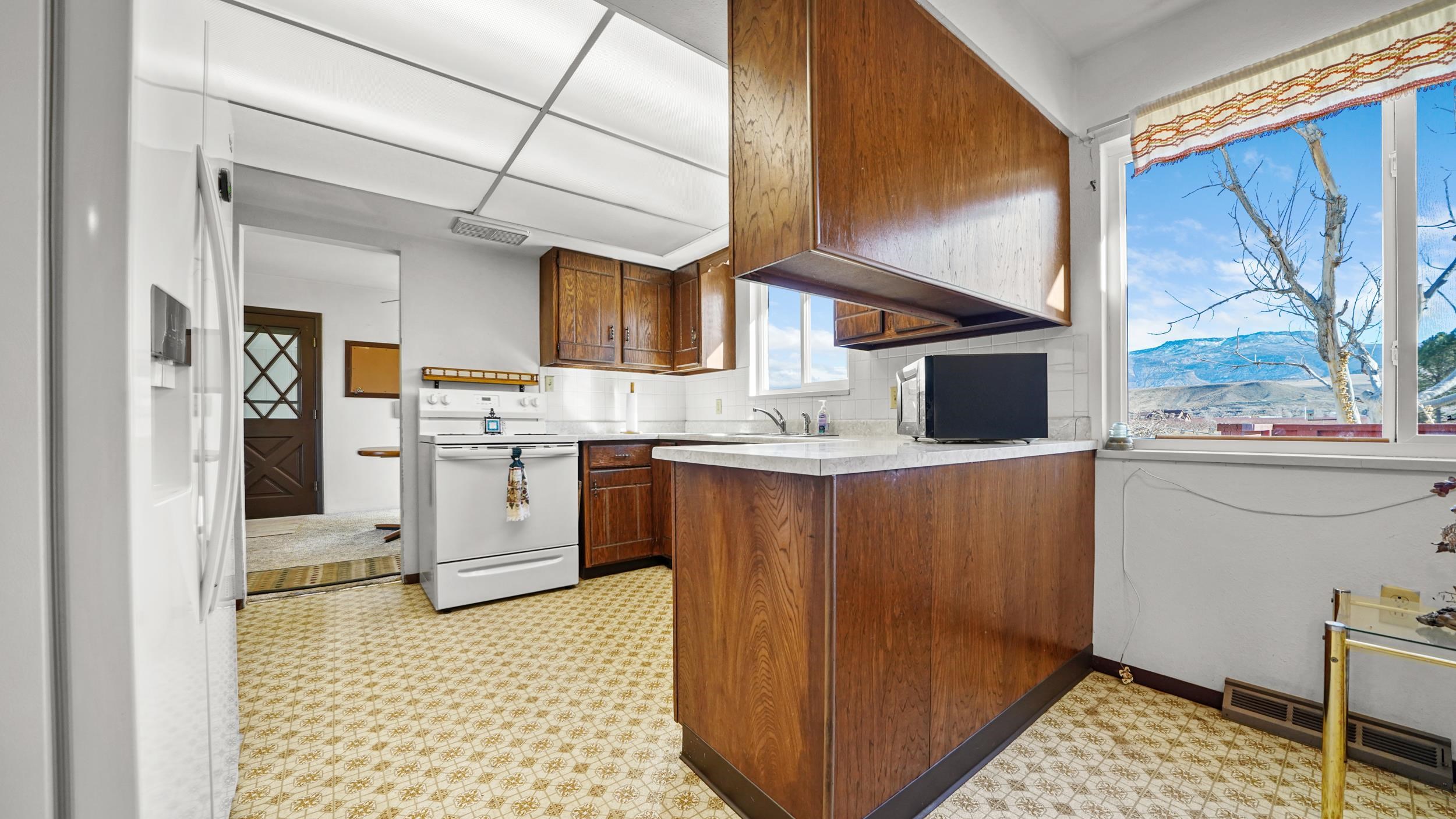 582 36 Road Palisade, CO 81526 - Photo 8 of 31 a kitchen with stainless steel appliances granite countertop a refrigerator a sink and white cabinets
