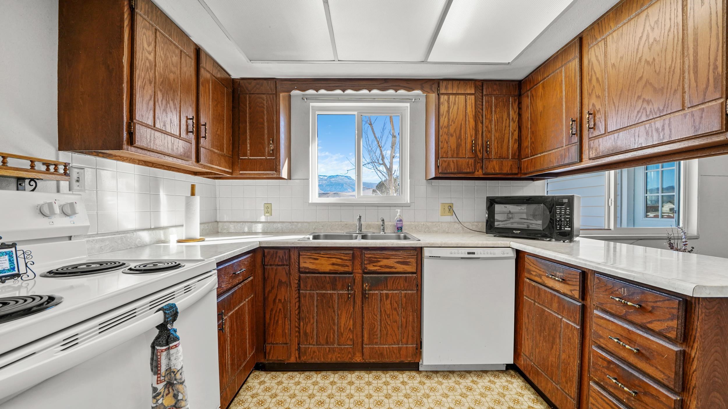 582 36 Road Palisade, CO 81526 - Photo 9 of 31 a kitchen with stainless steel appliances granite countertop a stove a sink dishwasher and a microwave oven on the cabinets