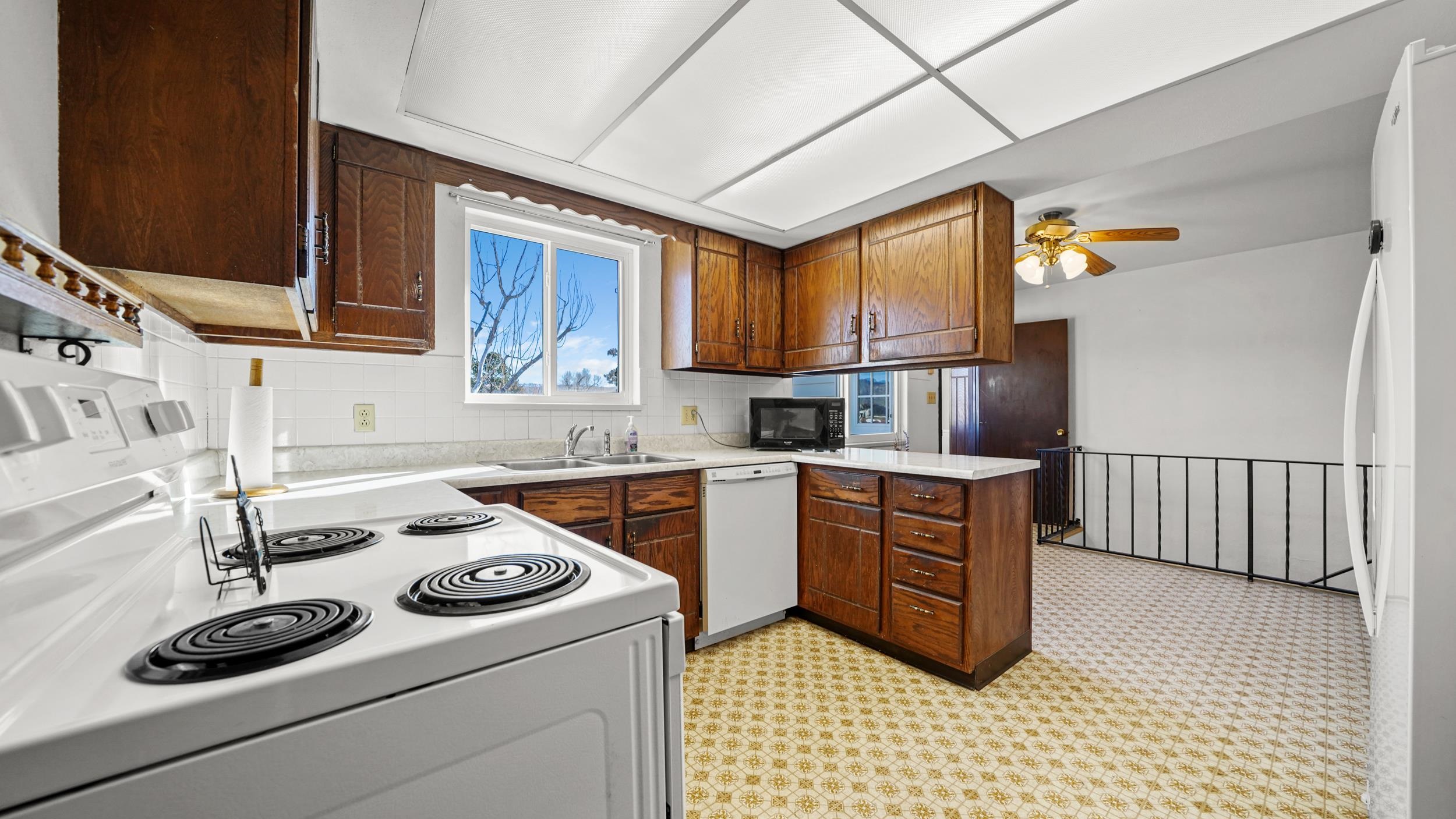 582 36 Road Palisade, CO 81526 - Photo 10 of 31 a kitchen with a stove a sink and a refrigerator
