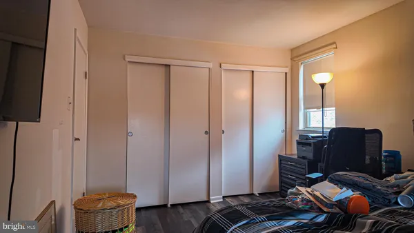 a bedroom with a bed and dresser