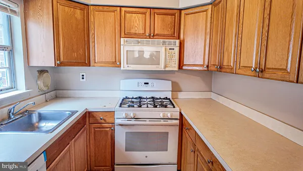 a kitchen with a stove a sink and a window
