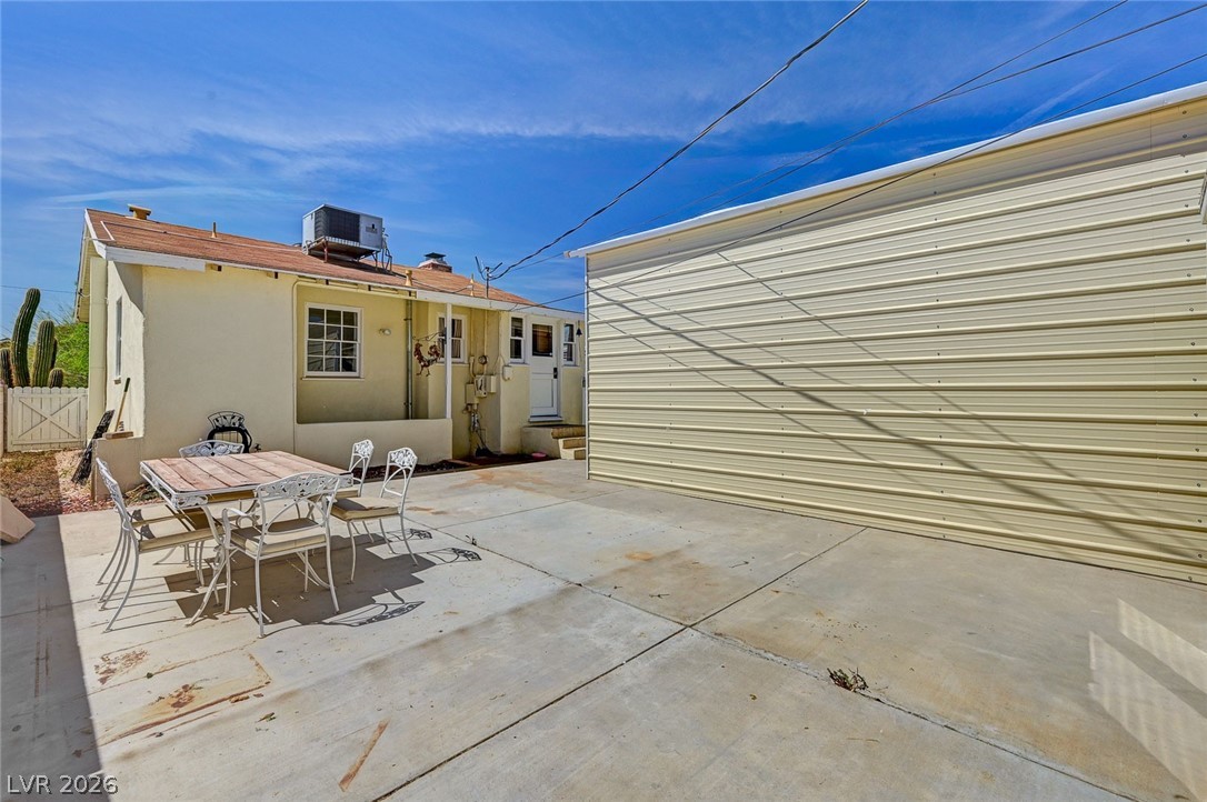 629 L Avenue Boulder City, NV 89005 - Photo 41 of 46 Back of property with a patio area, outdoor dining space, and stucco siding