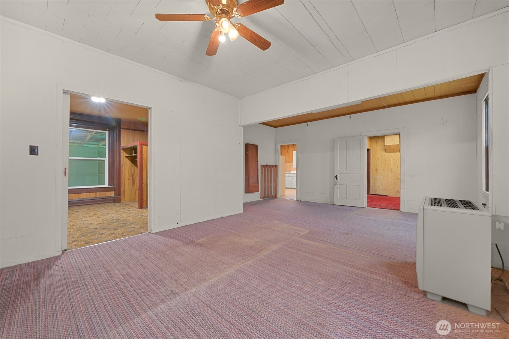 2701 Michigan Street Bellingham, WA 98226 - Photo 17 of 39 a view of an empty room with wooden floor and a ceiling fan