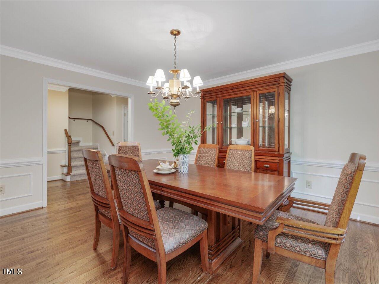 10609 Chinkapin Place Raleigh, NC 27613 - Photo 17 of 78 a view of a dining room with furniture wooden floor and chandelier